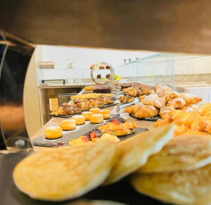A tempting pastry buffet: croissants, sweets, and cakes, evoking bakery aromas.