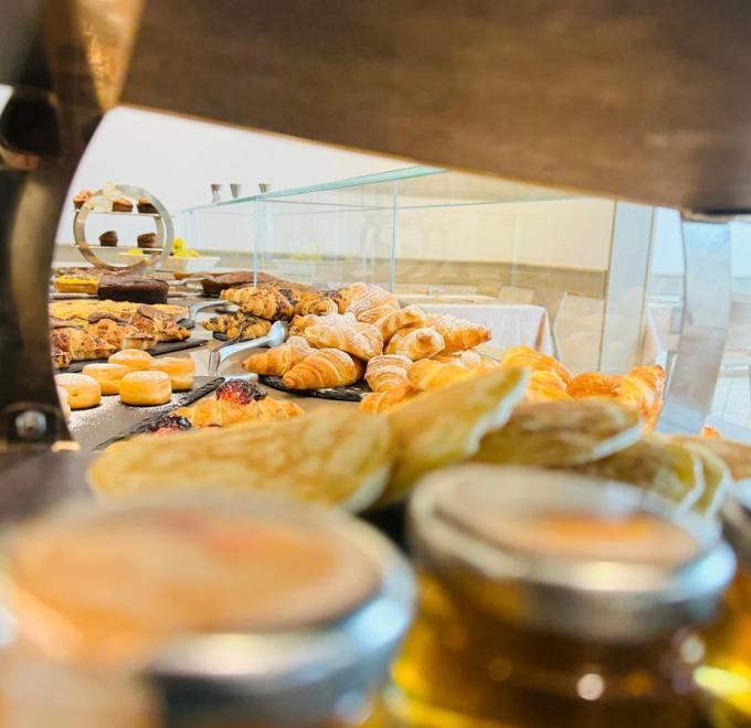 Delicious breakfast pastries, croissants, and cakes in an inviting buffet.