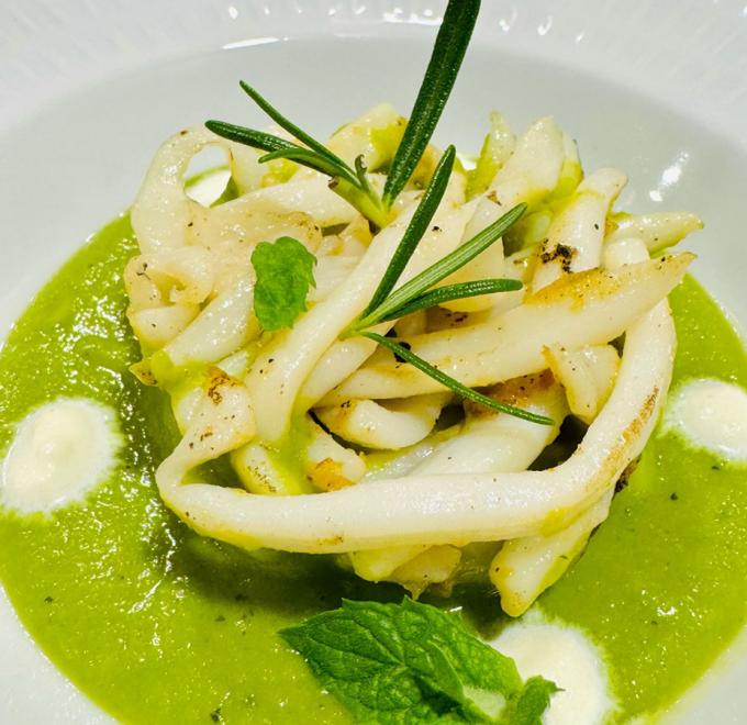 Squid on green puree, garnished with rosemary and mint, elegance and freshness.